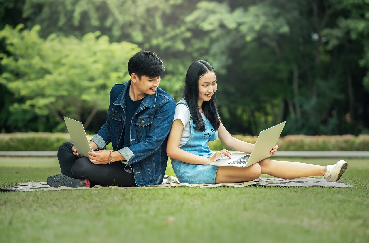 two students studying in a park